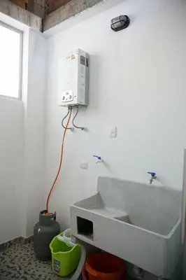 a bathroom with a sink in a white wall at Jatun Coya in Huancayo