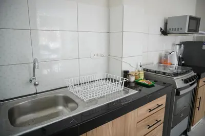 a small kitchen with a sink and a stove at Jatun Coya in Huancayo