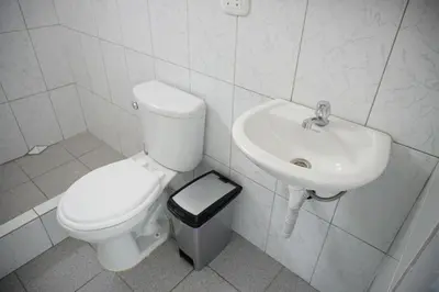 a bathroom with a toilet and a sink at Jatun Coya in Huancayo