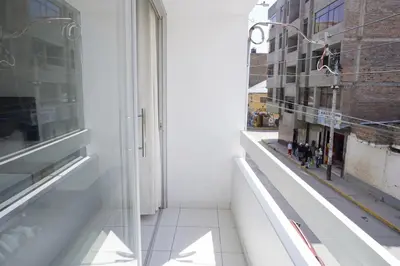 an empty room with a window and a building at Jatun Coya in Huancayo