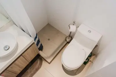 a small bathroom with a toilet and a sink at Charming 3BR in Barranco in Lima