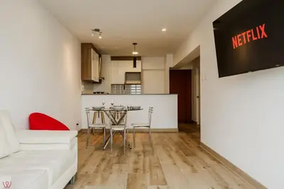 a living room with a white couch and a table at Polished 2BR with Balcony in San Isidro in Lima