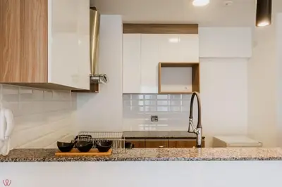 a kitchen with white cabinets and a sink at Polished 2BR with Balcony in San Isidro in Lima