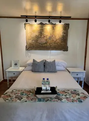 a bed with two bottles of water on it at Cabaña con linda vista en Oxapampa in Oxapampa
