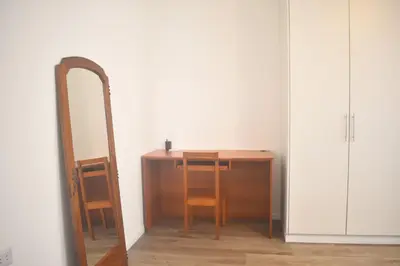 a mirror and a table with a chair and a desk at MirandoelMar - Luna in Lima