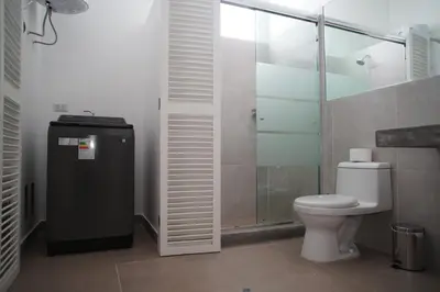 a bathroom with a toilet and a glass shower at MirandoelMar - Luna in Lima
