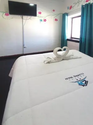 a bed with two white swans on top of it at Ccapaq Wasi II in Cusco