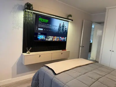 a bedroom with a flat screen tv on the wall at Art10 Milu - Miraflores-Larcomar in Lima