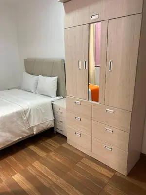 a bedroom with a dresser and a bed with a mirror at Departamentos Sumaq Plaza II in Ayacucho