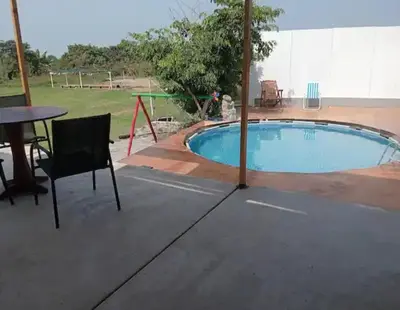 a swimming pool with a table and a table and a chair at Casa En Asia in San Antonio