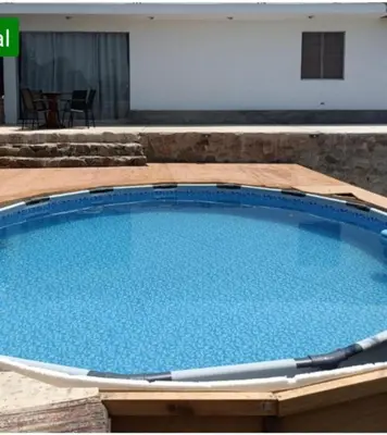 a large swimming pool with blue water at Casa En Asia in San Antonio