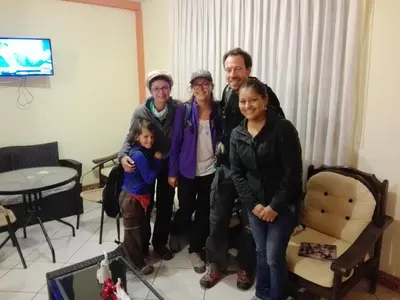 a group of people posing for a picture in a living room at Nasca Travel One Hostel in Nazca