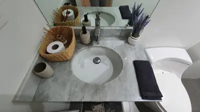 a bathroom counter with a sink with baskets on it at Beautiful and spacious apartment in San Felipe in Lima
