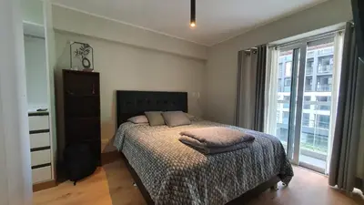 a bedroom with a bed and a large window at Beautiful and spacious apartment in San Felipe in Lima