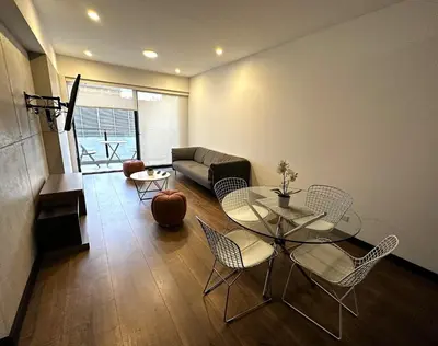 a living room with a table and chairs and a couch at 2 Bedroom Apartments San Isidro Business Zone in Lima