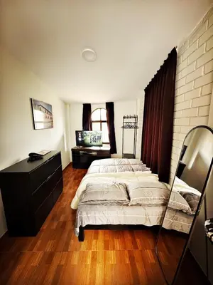 a bedroom with two beds and a dresser at Mini Apartamento BARRANCO in Lima