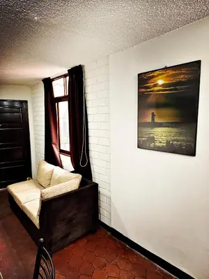 a living room with a couch and a picture on the wall at Mini Apartamento BARRANCO in Lima