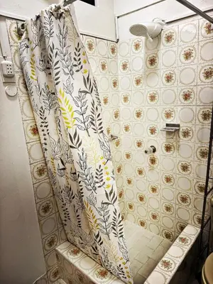 a shower curtain is hanging in a bathroom at Mini Apartamento BARRANCO in Lima