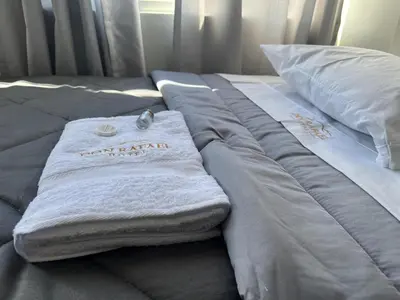 a bed with a towel on top of it at Don Rafael - Hotel
