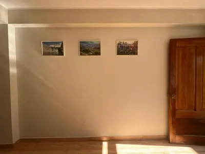 three paintings on a white wall in a room at Don Rafael - Hotel