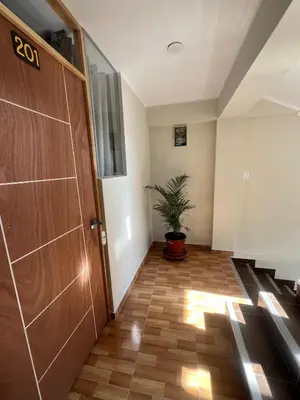 a hallway with a door and a potted plant at Don Rafael - Hotel