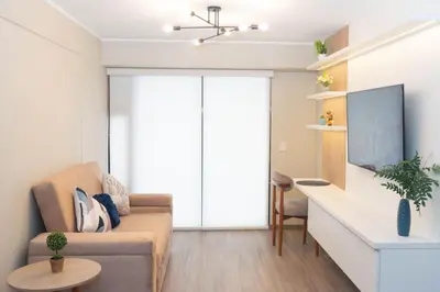 a living room with a couch and a table at Estilo y comodidad in Lima