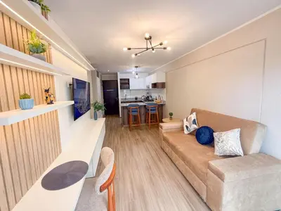 a living room with a couch and a kitchen at Estilo y comodidad in Lima