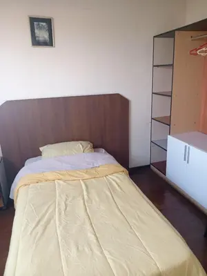 a bedroom with a bed with a wooden headboard at Habitación acogedora amoblada in Lima