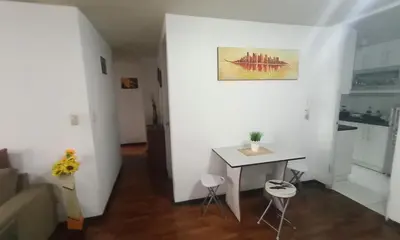 a white room with a table and chairs in it at Habitación acogedora amoblada in Lima