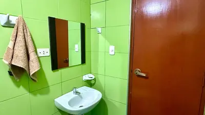 a bathroom with a sink and a mirror at WIFI Rápido A 20 min del Aeropuerto de Lima in Lima