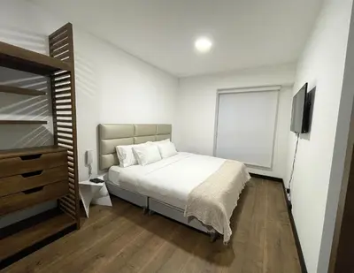 a bedroom with a bed and a television in it at 1 Bedroom Apartment San Isidro Business Zone in Lima