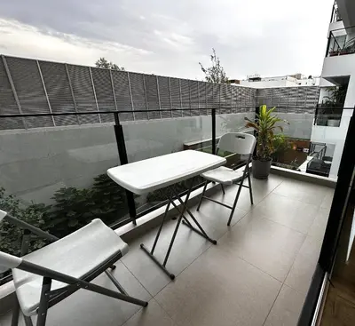 a white table and chairs on a balcony at 1 Bedroom Apartment San Isidro Business Zone in Lima