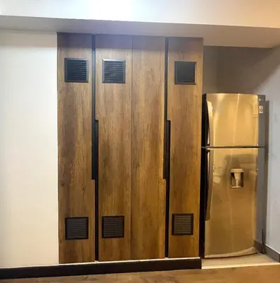 a row of wooden lockers with a stainless steel refrigerator at 1 Bedroom Apartment San Isidro Business Zone in Lima