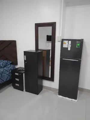 a room with a black refrigerator and a mirror at Monoambiente de estreno 35 m2 in Lima