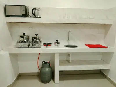 a kitchen counter with a sink and a microwave at Monoambiente de estreno 35 m2 in Lima