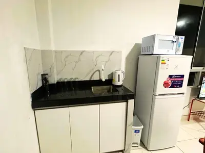 a kitchen with a sink and a refrigerator at RELAX Y PISCINA con vista al MAR - DUPLEX in Cerro Azul