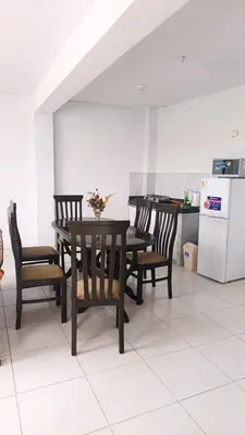a dining room with a table and chairs and a kitchen at RELAX Y PISCINA con vista al MAR - DUPLEX in Cerro Azul