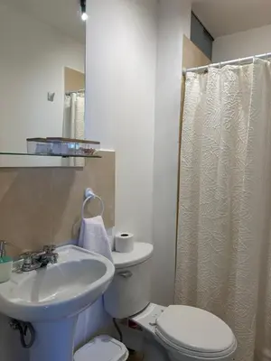 a bathroom with a sink and a toilet and a shower at Casita en Ica con piscina in Ica