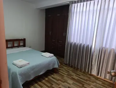 a bedroom with a bed with two towels on it at Casa Hamuys - Ica in Ica