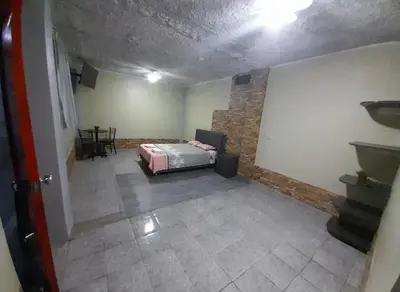 a room with a bed and a stone wall at El titanic in Nazca