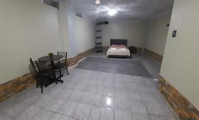 a room with a bed and a table in it at El titanic in Nazca