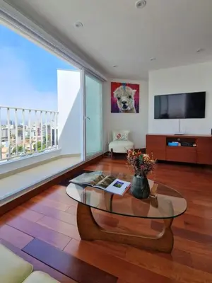 a living room with a table and a large window at Beautiful Duplex in the Heart of Miraflores in Lima