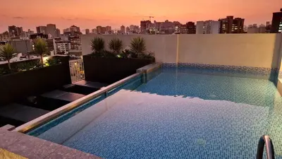 a swimming pool on top of a building with a city at Beautiful Duplex in the Heart of Miraflores in Lima