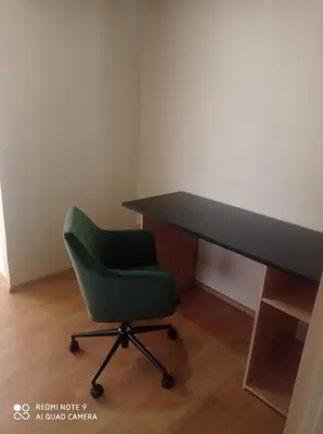 a desk and a green chair in a room at Cozy Furnished Brand New Apartment