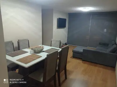 a dining room with a table and chairs and a couch at Cozy Furnished Brand New Apartment