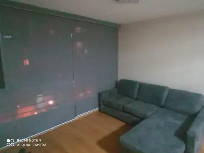 a living room with a couch and a window at Cozy Furnished Brand New Apartment