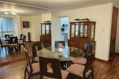 a dining room with a glass table and chairs at Bella vista al mar y Larcomar - Miraflores in Lima