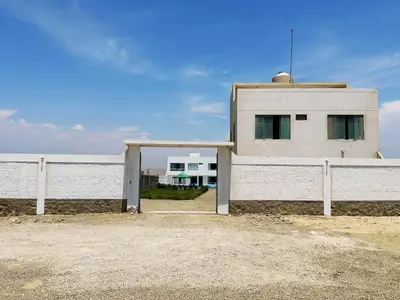 a white building next to a white fence at RELAX Y PISCINA con vista al MAR - FLAT in Cerro Azul