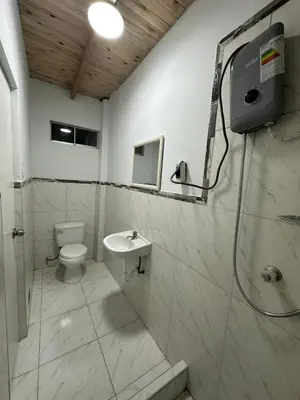 a bathroom with a toilet and a shower and a sink at Casa de campo relax y piscina in Cerro Azul