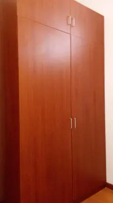 a wooden cabinet with two doors in a room at Fundo Hotel Ayarpongo in Churín